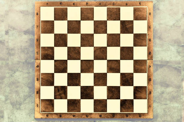 istock Brown wooden chessboard on a gray background. space for text 1818886864