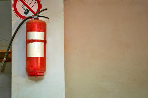 istock Fire extinguisher on the wall in the basement with a no smoking sign 1818887946