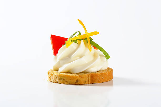 bread rusk with fresh cream cheese and vegetable decoration on a white background