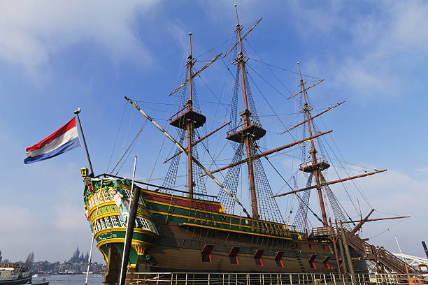 Old VOC sailing ship Halve Maen replica sailing at the IJsselmeer in Flevoland, The Netherlands with the former island Urk in the background on the horizon. The Halve Maen was a trading ship of the Dutch East India Company (Dutch: Verenigde Oost-Indische Compagnie and sailed up the Hudson into what is now New York Harbor in 1609.