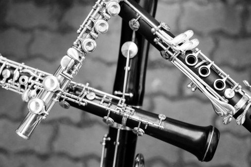 Oboe player hands. Woodwind musical instrument on black background  detail closeup