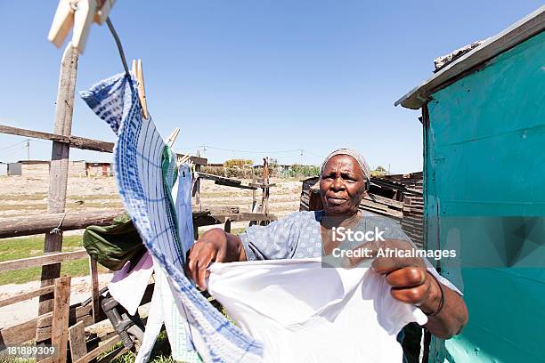 African Woman Hanging Up Laundry Stock Photo - Download Image Now - Senior Adult, South Africa, South African Culture