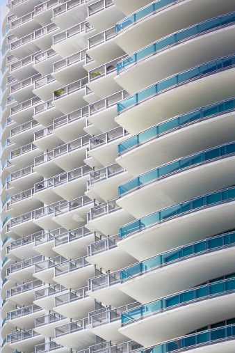 Photo of a building facade with many balconies.