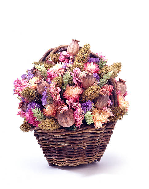 Artificial flowers in woven basket on white background