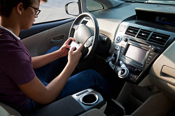 istock Teenager texting in car 181889881