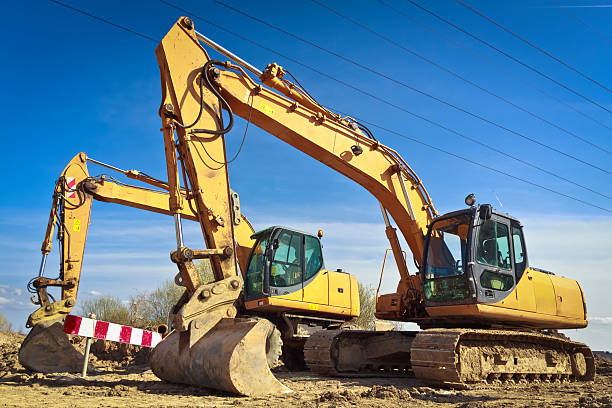 istock Yellow excavators in a new road construction 181889897