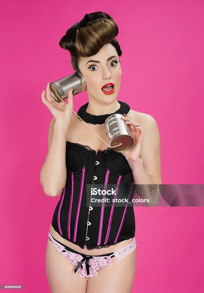 pin up woman with tin can phone amazed woman with tin can phone. 1960-1969 Stock Photo