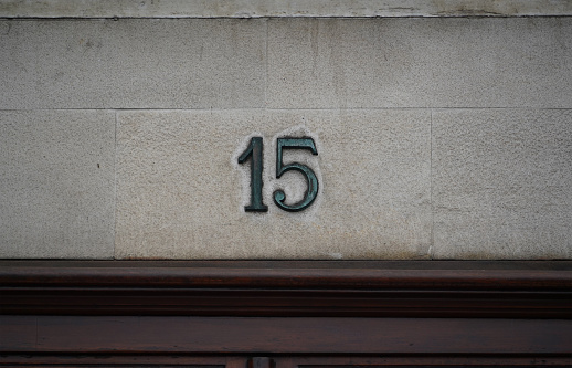 Fifteen number on the faccade in a street in Santander, Spain