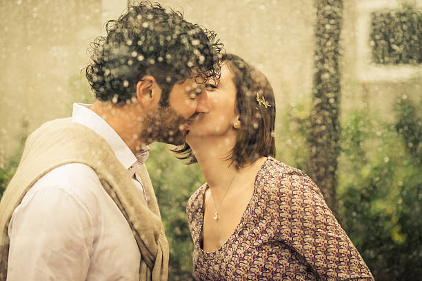 istock Romantic Couple Kissing Behind Wet Window 181890380