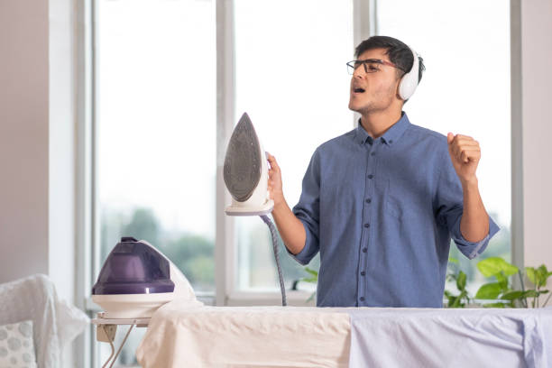 istock Young man playfully ironing his own laundry at home. 1818905524