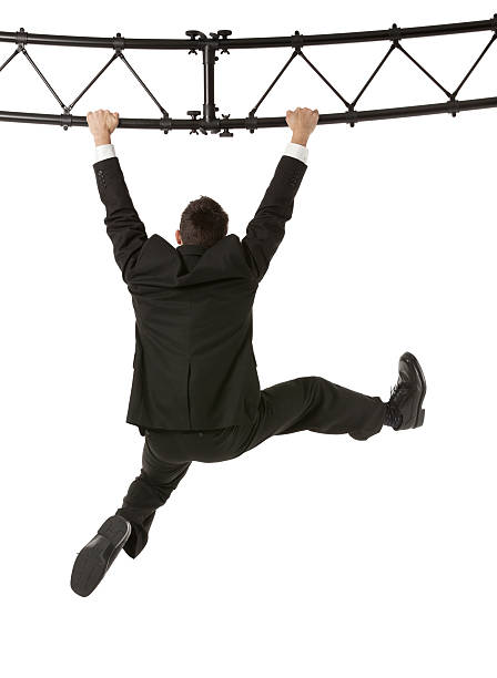 istock Businessman hanging from a metal structure 181890595