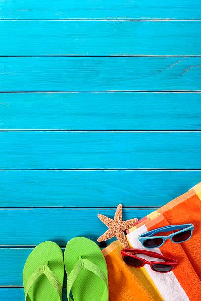 istock Beach accessories on a vivid blue painted wood deck 181890851