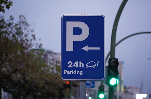 Sign indicating 24-hour parking that has a charger for electric cars