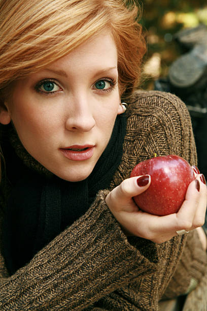 Fall Portrait young woman (twenty-one) with apple - shot outside modelce stock pictures, royalty-free photos & images