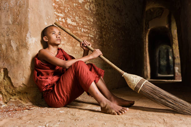 istock Novice Buddhist monk inside the temple 181891374