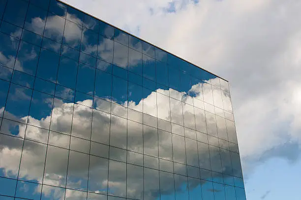 Reflection of the cloudy sky in the office building