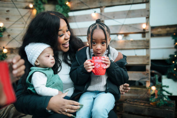 istock Mother And Daughters Outside During Holiday With Hot Drinks 1818921657