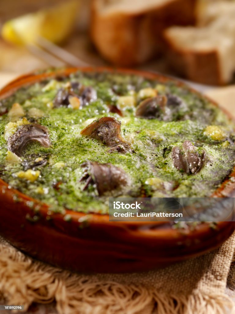 snail "Escargot in a Herb Butter, White Wine and Garlic Sauce with Fresh Parsley and Crusty French Bread -Photographed on Hasselblad H3D2-39mb Camera" Appetizer Stock Photo