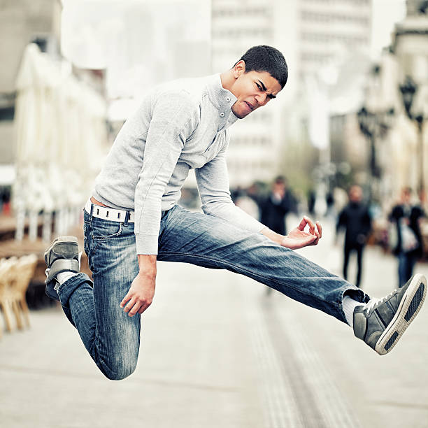 Rock 'n' Roll Baby! Energetic young man playing air guitar. air guitar stock pictures, royalty-free photos & images