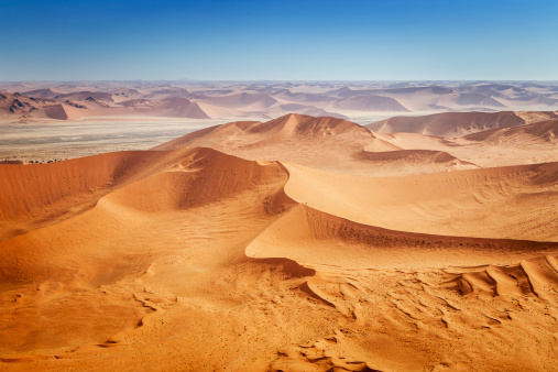 Badain Jaran Desert in Inner Mongolia, China, the third largest desert in China, with the tallest stationary dunes on Earth blue sky, white clouds in background, black and white