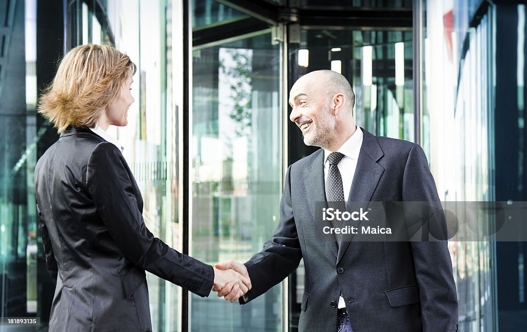 Business people meeting at a building entrance Business people shaking hands.Many more of this session and models at this lightbox (click any thumbnail for opening) Door Stock Photo