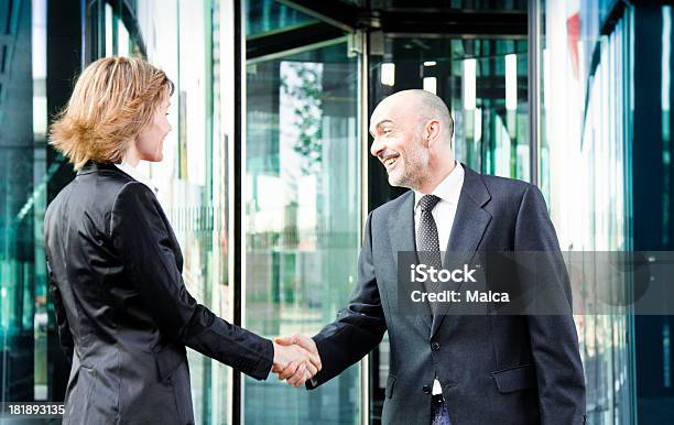 Business People Meeting At A Building Entrance Stock Photo - Download Image Now - Door, Handshake, Outdoors