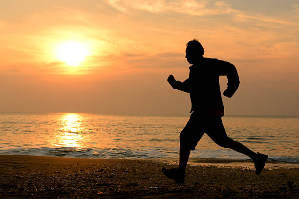 istock Silhouette running at the beach 181893235
