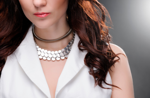 front view of young woman wearing necklace.elegance concept.