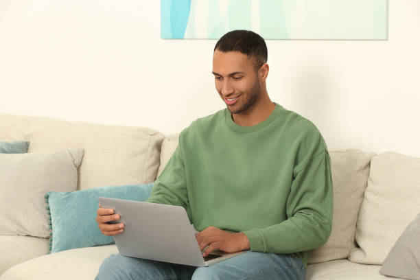 istock African American man working on laptop at home 1818938605