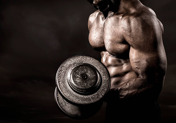 Bodybuilder performing power lift curl stock photo