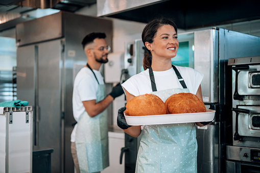 A shot highlights the art of collaboration between the male and female workers, showcasing their combined skills and dedication to delivering exceptional bakery products to their customers