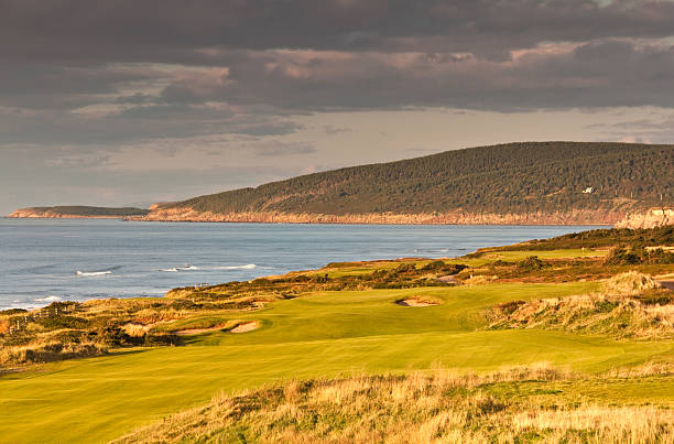 Beautiful Links Golf Course A beautiful golf course by the ocean. Golf scenic. Horizontal colour image. Links golf course in Nova Scotia, Canada in Cape Breton. Links golf is common in Scotland, where the game began. Links is the seaside land that "links" the sea to the "good" land. It's sandy, windswept and rugged look is ideal for golf.  cabot trail stock pictures, royalty-free photos & images