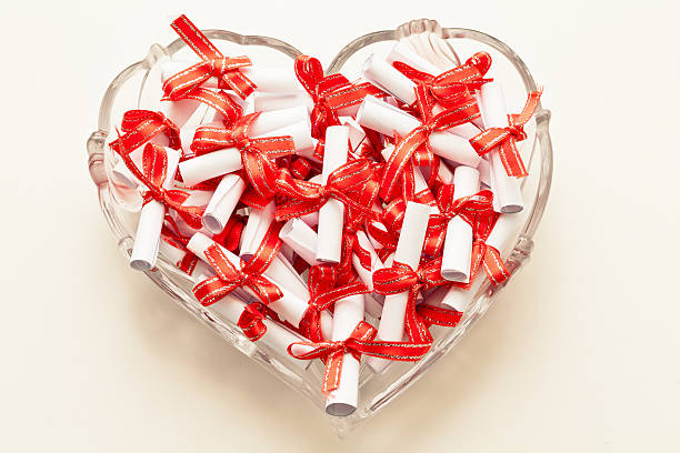 rolls of paper tied with red ribbon stock photo