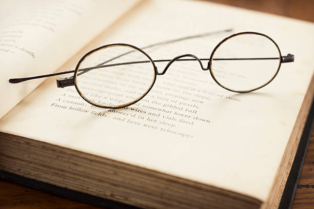 istock Antique Wire Frame Eyeglasses on an Old Book 181894573
