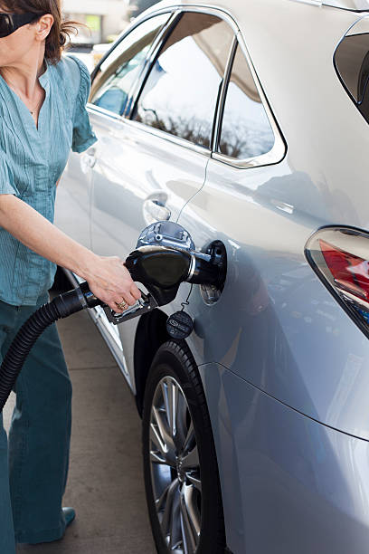 istock Woman Refueling Car 181895101