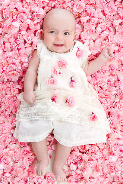 istock Baby with pink flowers 181895192
