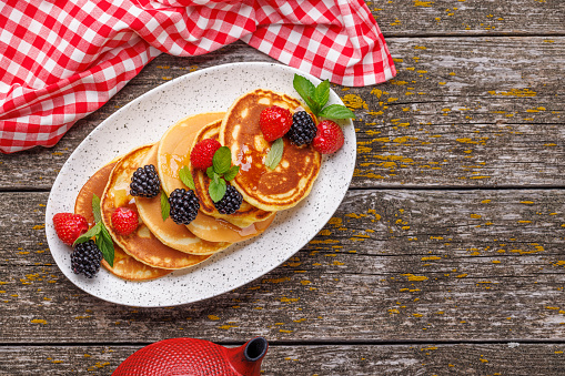 Tasty homemade pancakes with berries. Flat lay with copy space