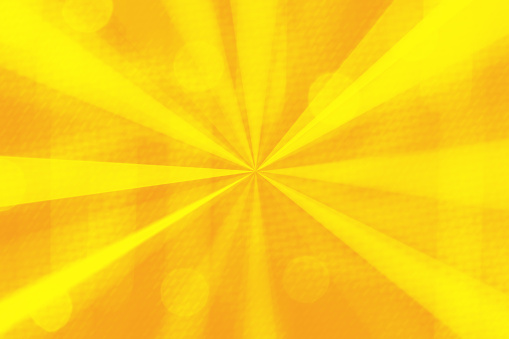 Abstract yellow light beams background with bokeh.
