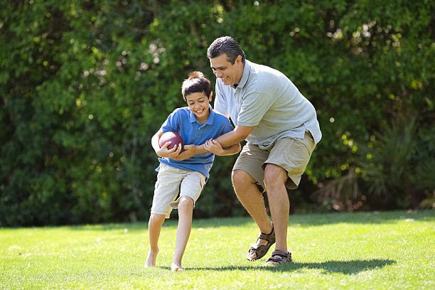 istock Father Playing American Football With Son 181895541