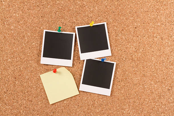 istock Blank Instant Photo Prints with Post-it on Corkboard 181895618