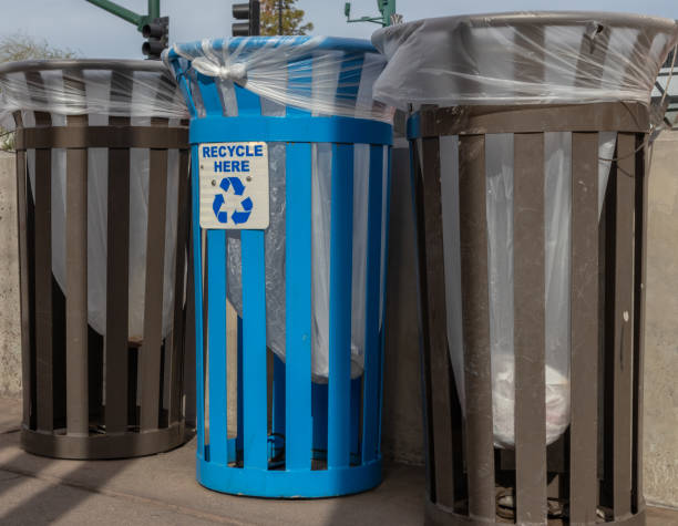 istock Blue recycle bin with two trash bins in city street 1818960484