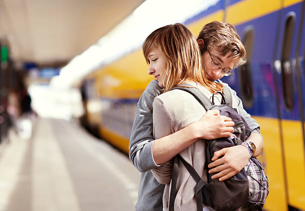 istock young couple hugging against  train at the background 181896058