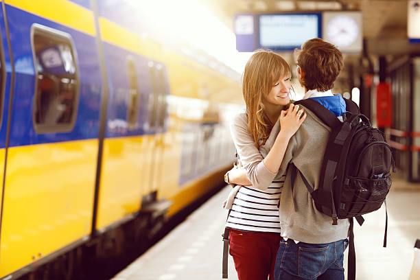 istock happy young couple at the railway station 181896059