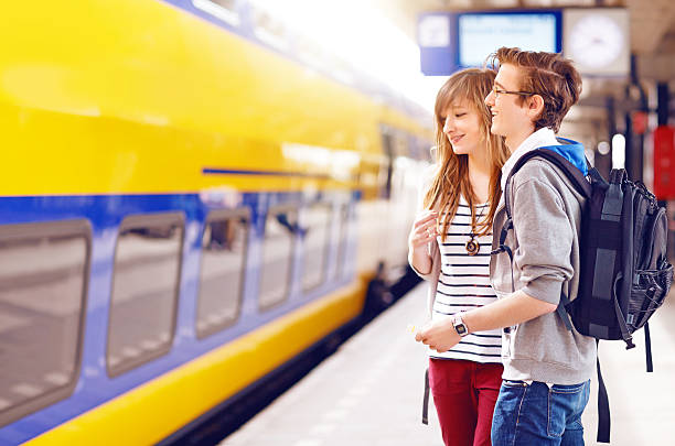 happy students going to travel by train