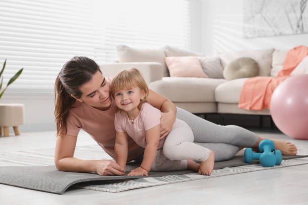 istock Mother doing exercise with her daughter at home 1818962103