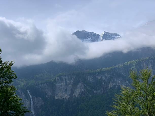 istock Scenic and tranquil landscape featuring a mountain range partially obscured by clouds 1818963316