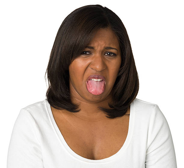 istock Disgusted Young Woman Sticks Out Tongue 181896356