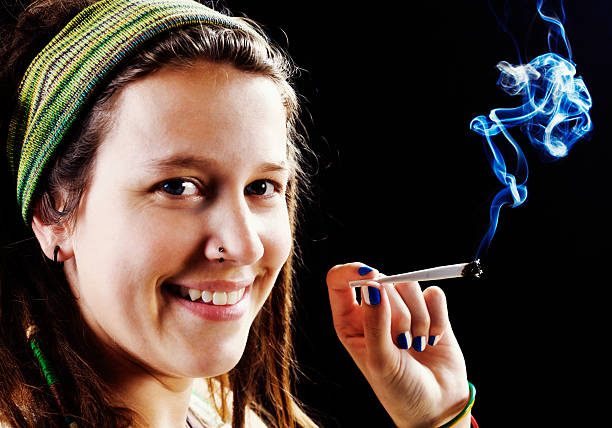 istock Happy hippie with hand-rolled marijuana joint 181896360