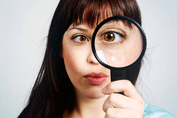 istock I can see clearly now! Female eye through magnifying glass 181896556