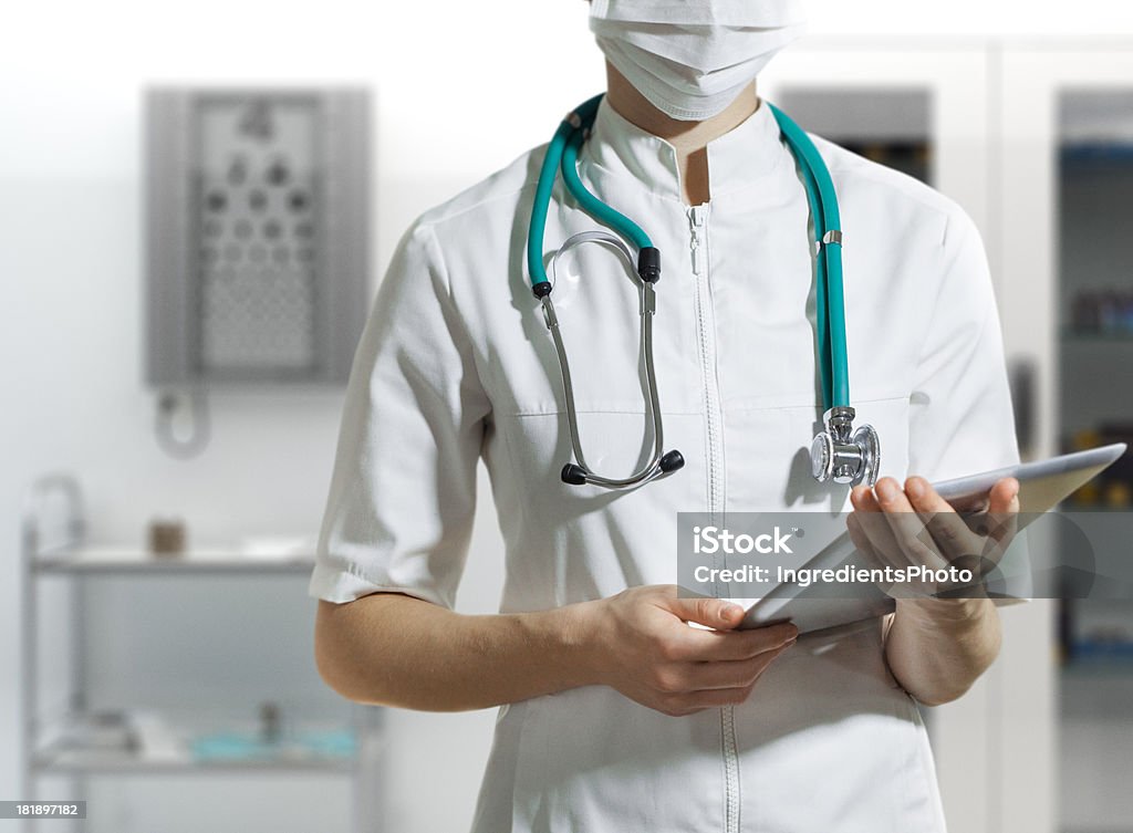 Doctor en el hospital agarrando una tableta digital. - Foto de stock de Accidentes y desastres libre de derechos